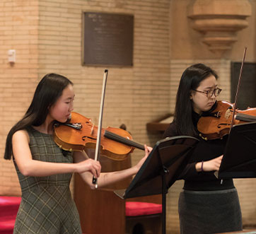 Photo of students playing violins. Links to Closely Held Business Stock